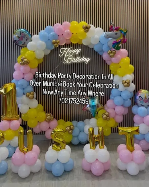 A dreamy unicorn-themed decoration for Pushti's birthday. This setup features a pastel-colored balloon ring, unicorn foil balloons, and custom name lettering made from balloons.