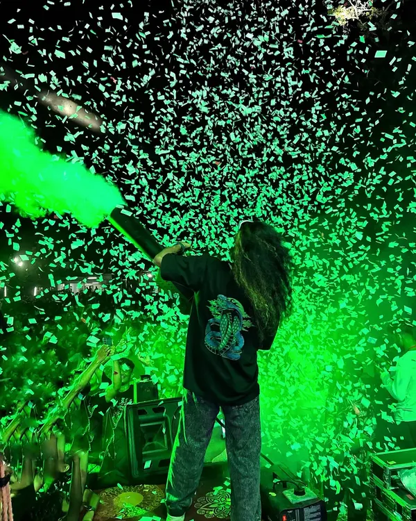 Blasting the crowd with green light and confetti. The use of color and effects is key to creating the high-energy atmosphere of my shows.