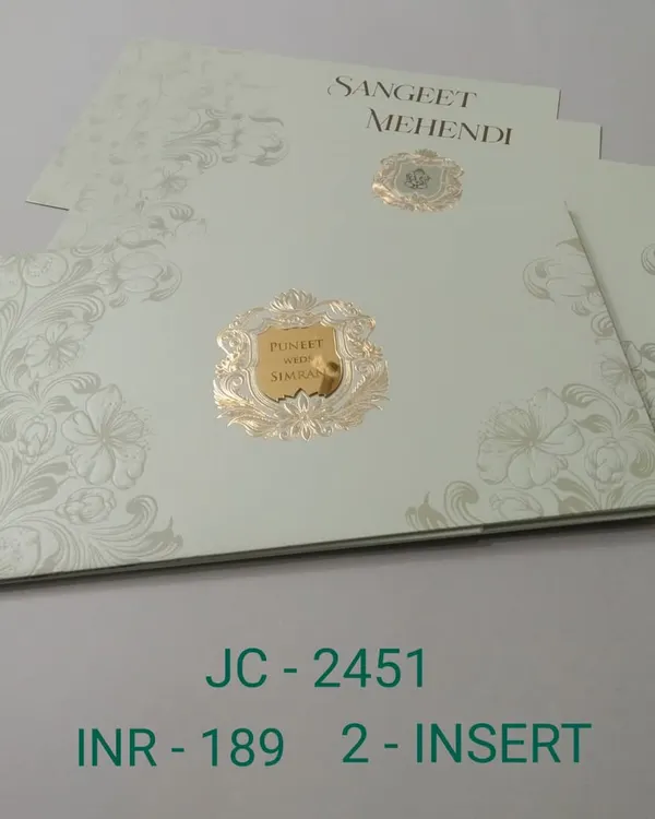 This elegant invitation uses a simple color palette of off-white and gold. The design features a classic crest and subtle floral embossing for a touch of texture.