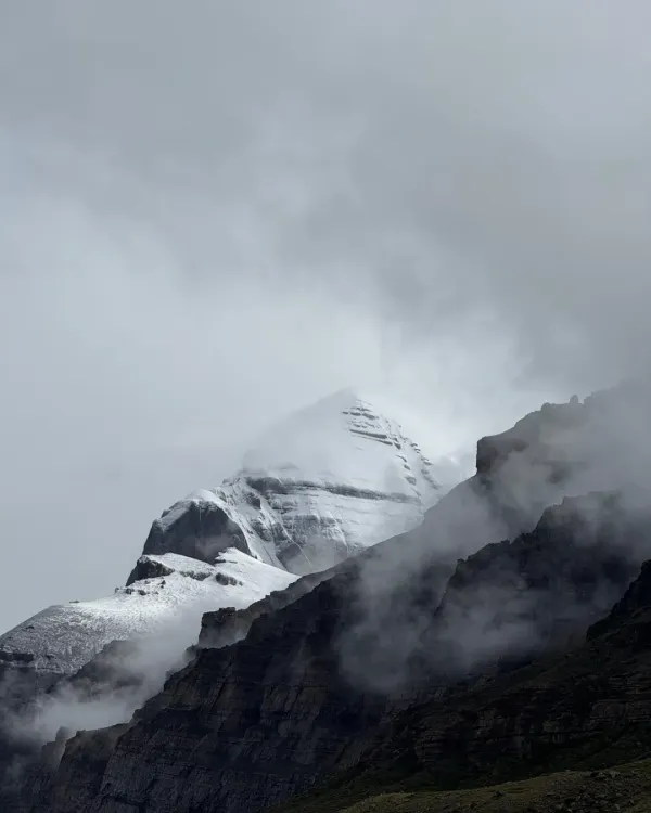 The sacred Mount Kailash, veiled in mist and cloud. To be in its presence is not a destination to be reached, but a grace to be received. This is the heart of our yatra, a moment of profound stillness and darshan.