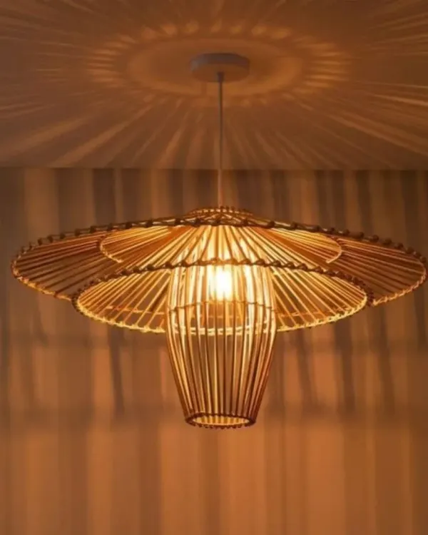 This wide, flower-like bamboo pendant light casts beautiful, patterned shadows on the ceiling, creating a dramatic effect. Its intricate, layered design makes it a stunning centerpiece for a living room or entryway, providing both light and artistry.