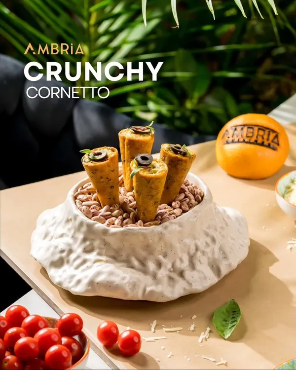 My Crunchy Cornetto, a bite-sized appetizer filled with a savoury mixture and topped with an olive. It's a perfect example of creative, fusion finger food.