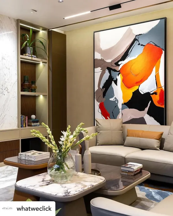 My 'Colour Cluster' abstract painting featured in a client's living room. The large-scale canvas, with its bold splashes of red, orange, and blue, acts as a dynamic and energetic focal point for the entire space.