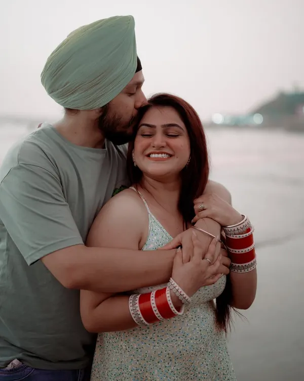 A tender forehead kiss against the soft light of the evening sky in Goa. This post-wedding shoot captures the quiet, happy moments after the main celebration is over.