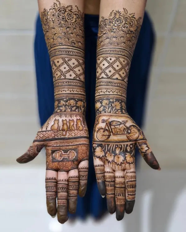 A full view of the custom bridal mehendi, showing how the personal elements on the palms transition into traditional patterns on the arms.
