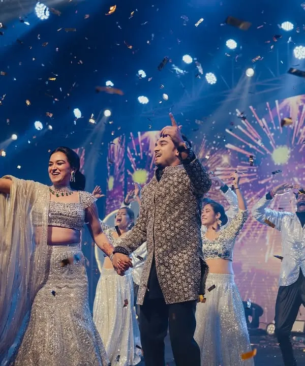The grand finale of a couple's performance. Nipun and Roshni are showered in confetti, surrounded by dancers, with fireworks on the LED screen. This is the kind of high-energy, celebratory moment we love to create.