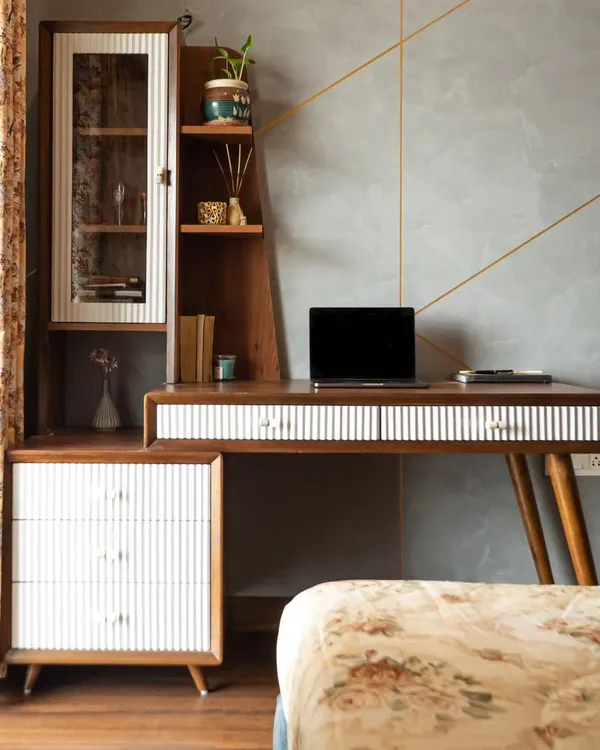 A gorgeous work desk can make Monday mornings a little brighter. This study area from our Neelabh project combines a sleek, mid-century modern desk with an attached storage unit, offering ample space to stay organized and productive.