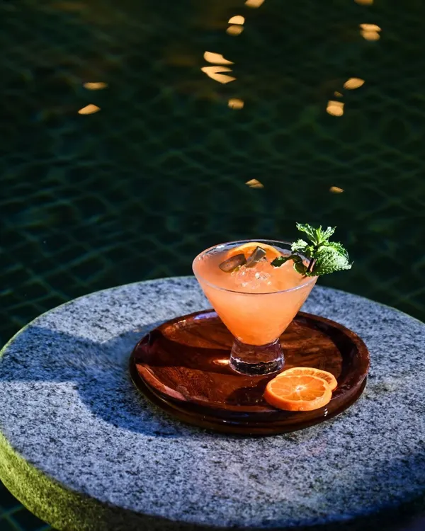 Our 'garden-to-glass' philosophy comes to life in this refreshing orange and mint cocktail, served by the pool. Each sip is a taste of the fresh, seasonal ingredients grown right here at our resort.