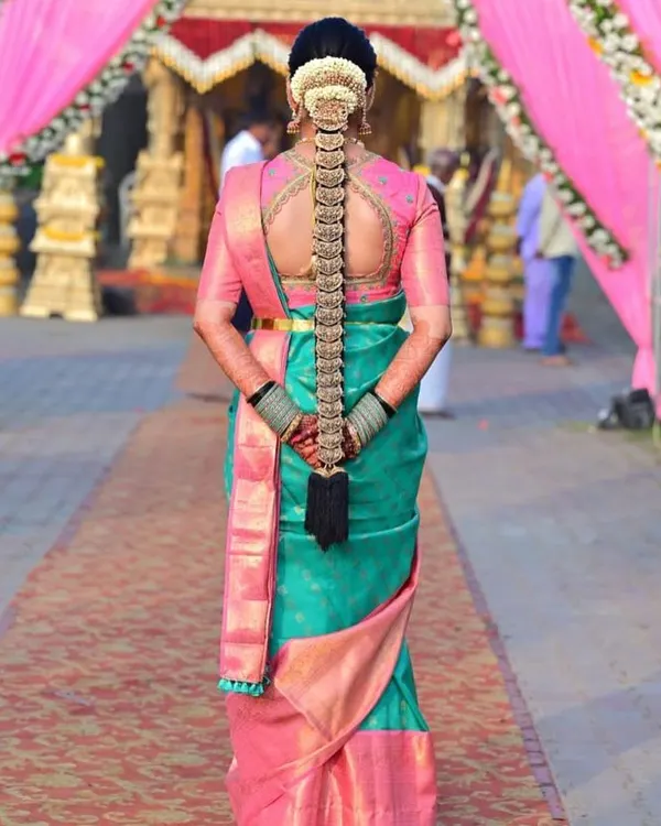 This is what I love to create. A custom hand-embroidered blouse for a beautiful bride, designed to perfectly complement her Kanchipuram silk saree and traditional temple jewelry. The intricate back detailing ensures she looks stunning from every angle on her big day.