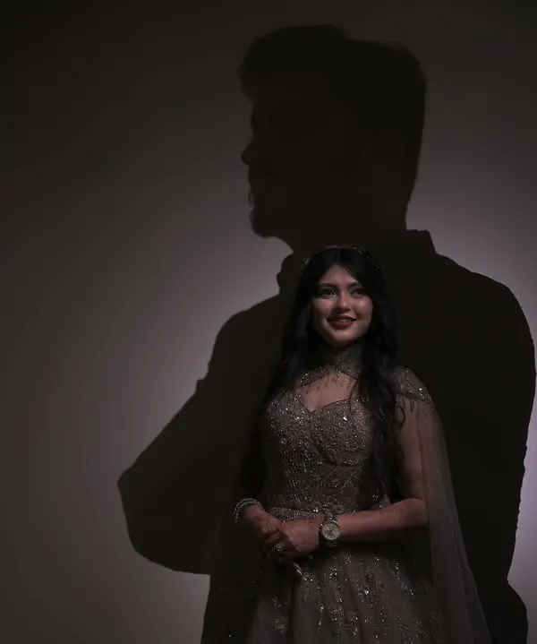 In her smile, he lives. A conceptual couple portrait using the groom's shadow to frame the bride, symbolizing his love lighting up her world.