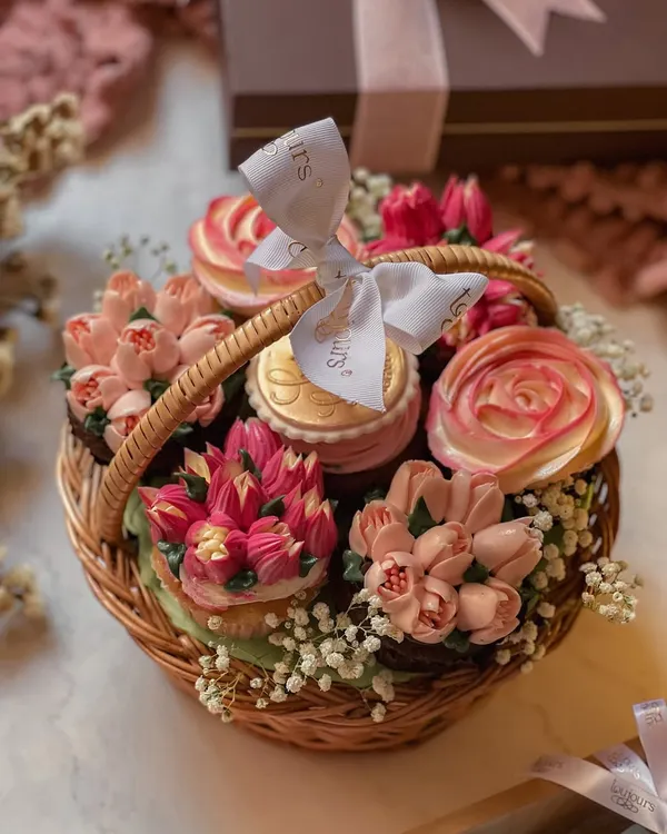 My handcrafted cupcake basket for Mother's Day, featuring an assortment of cupcakes piped with intricate buttercream flowers and nestled in a rustic wicker basket. It's an edible bouquet that tastes as lovely as it looks.