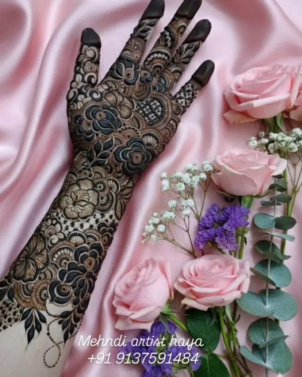 This is what I call putting your whole 'ishq' into the art. A full-sleeve bridal henna design featuring a dense pattern of bold florals and delicate shading to create a stunning 3D effect. This level of detail is my signature.