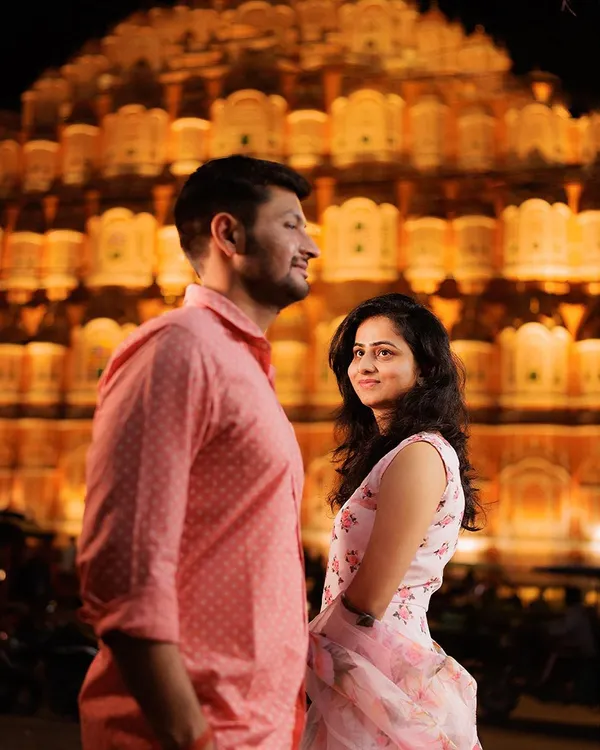 A stunning night portrait with the illuminated Hawa Mahal creating a grand, royal backdrop. This shot from a Jaipur pre-wedding session highlights our expertise in using iconic locations to create breathtaking images.
