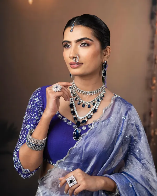 A modern and minimalist look perfect for a reception. I created a glowing, lit-from-within skin finish and paired it with a graphic blue and silver eye to complement the stunning saree.
