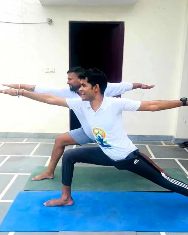 Guiding a client through Virabhadrasana II (Warrior II pose) during a personal training session. I focus on correct alignment and posture to ensure you get the maximum benefit from each asana.