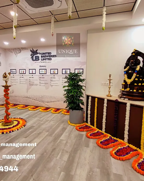 We designed this traditional and elegant setup for the office inauguration of United Breweries Limited. The decor features auspicious marigold flower arrangements, intricate floral floor patterns, and classic brass lamps to create a welcoming atmosphere for the opening ceremony.