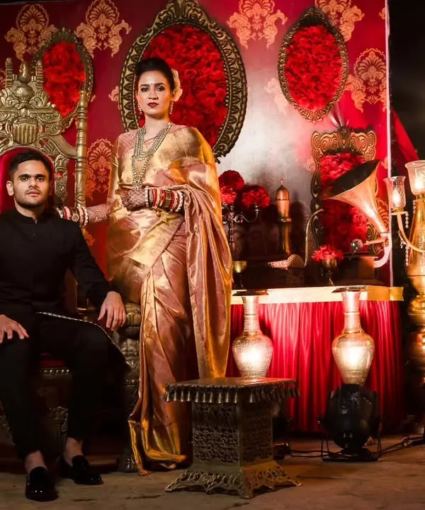 We designed this regal reception stage with ornate golden thrones and a rich red and gold backdrop. The setup is perfect for couples wanting a royal theme, creating a majestic setting for their evening celebration.