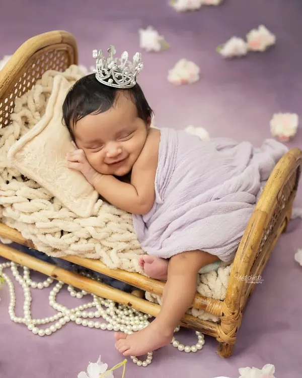 This is what pure joy looks like. I love capturing these heart-melting smiles on sleeping newborns, complete with a tiny crown for your little princess. These are the moments that become timeless treasures.