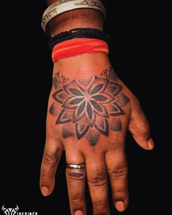 A bold geometric mandala on the hand, featuring clean lines and dot work shading. This style is excellent for covering old tattoos with a balanced and intricate design.