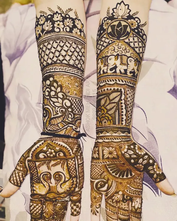 A beautiful example of full-arm bridal mehndi rich with classic motifs. The design features majestic elephants, graceful swans, lotus flowers, and intricate jaal (net) patterns for a timeless look.