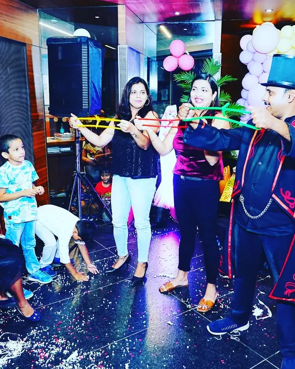 Getting the adults to participate with the classic linking rings illusion. It's always a highlight when the grown-ups are just as baffled as the kids.