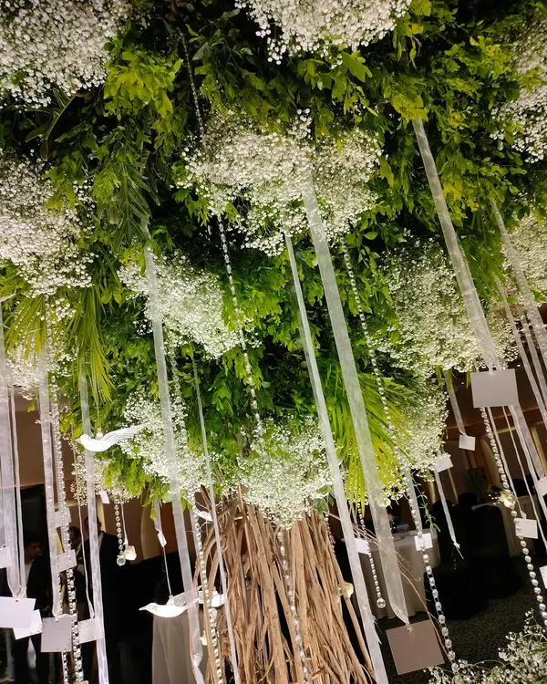 A closer look at our custom-built "Wish Tree." We hung crystals, acrylic birds, and personalized wish cards from its branches, creating an interactive and meaningful centerpiece for the reception.