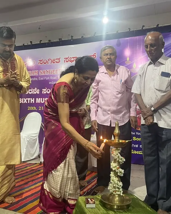 Lighting the lamp to inaugurate the Malleswaram Sangeeta Sabha music conference. This traditional ceremony marks the auspicious beginning of a celebration of music.