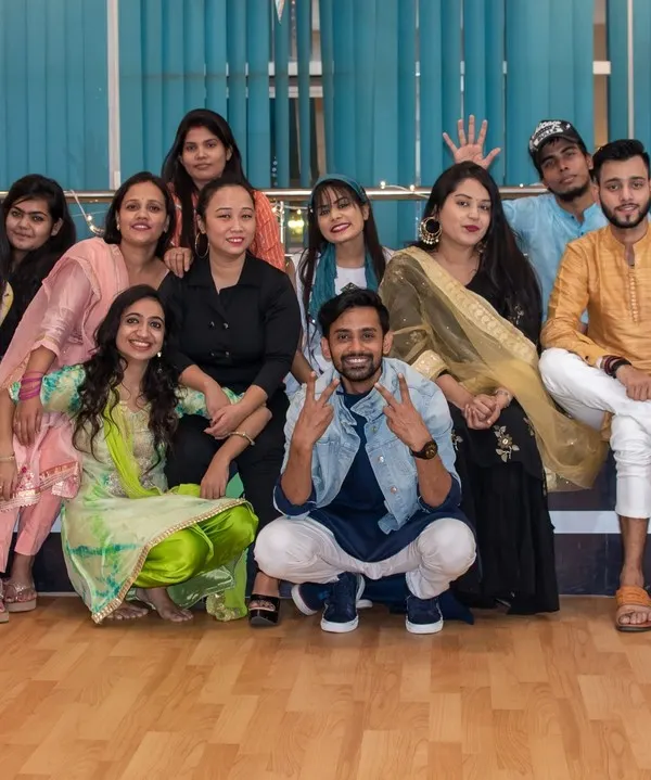 More than just a dance class, we are a family. This is our crew during a studio celebration, all dressed up and enjoying the festive vibe. I create this same sense of community and fun for your sangeet group, making rehearsals a memorable part of your wedding.