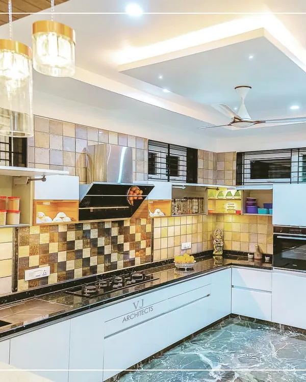 This modern L-shaped kitchen features a striking checkerboard tile backsplash and sleek white handleless cabinets. The overhead lighting and under-cabinet LEDs ensure the workspace is always well-lit.