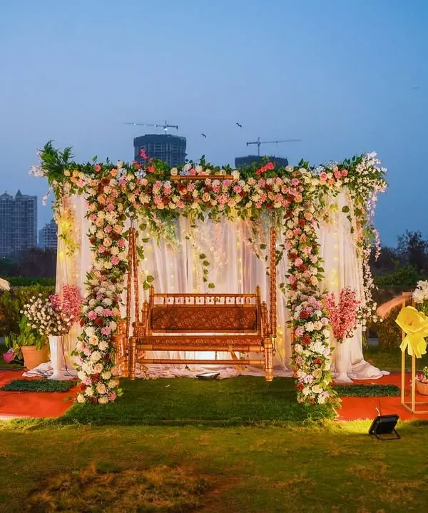 This sundowner baby shower setup is one of my proudest creations. The lush floral arch framing a traditional swing, combined with boho pampas grass and the city skyline at dusk, creates a truly magical and high-end feel for any outdoor celebration.