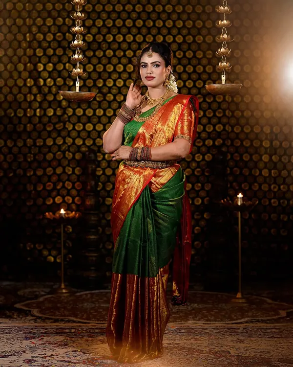 A full-length portrait from my Varamahalakshmi festival photoshoot. I styled myself in a traditional green and red silk saree with temple jewellery, creating a makeup look that was both festive and elegant.