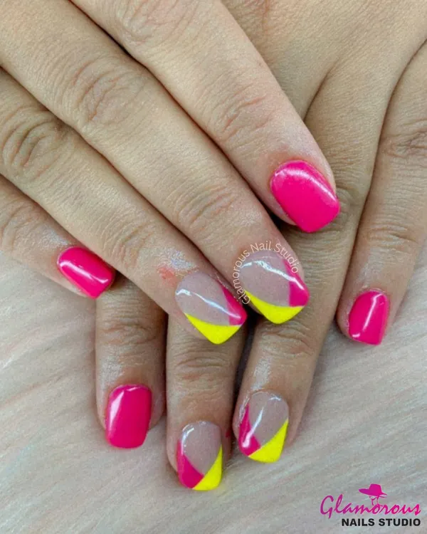 A fun and modern color-block design. We used a vibrant hot pink and a cheerful neon yellow to create this playful look on short, square-shaped nails.