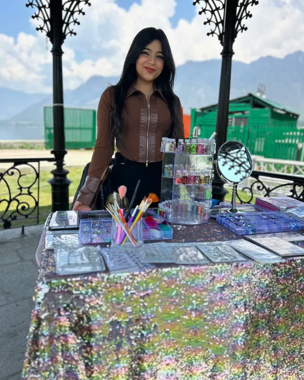 My setup for a beautiful outdoor event. Having a professional and inviting table with all your paints, brushes, and glitter organized is key to attracting clients.