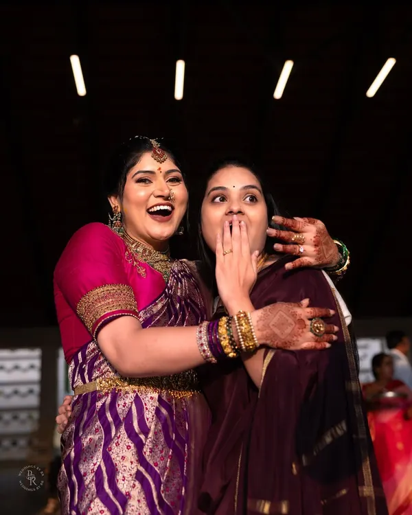 A moment of pure, uninhibited laughter and surprise between two friends at an engagement party. It's these candid shots that tell the real story.