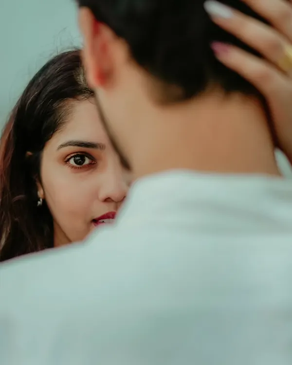 A beautifully composed shot focusing on the bride-to-be's expressive eyes. This intimate portrait of Jayashree captures a moment of quiet connection and love.