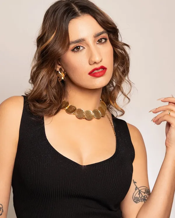The essence of modern glamour. This close-up showcases a classic bold red lip, soft waves, and clean, radiant skin, a look that is both timeless and effortlessly confident.