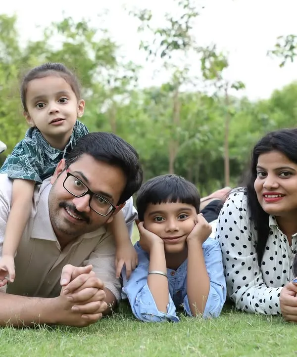 I believe the best family portraits happen when you can just be yourselves. This outdoor session in a Delhi park allowed for natural, relaxed moments like this one, with the whole family together on the grass.