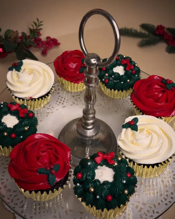 Christmas in a cupcake. This festive assortment includes classic chocolate and vanilla cupcakes decorated with vanilla bean frosting to look like wreaths, roses, and holly.