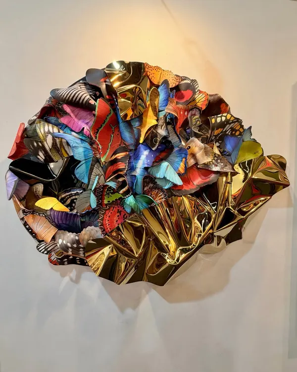 This piece, "Wings of Resilience," is a powerful symbol of transformation and hope. I layered polycarbonate butterfly wings over a hand-shaped, gold-toned stainless steel base to create a sense of collective flight and dynamic energy.