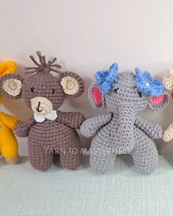 These are the individual characters for my jungle-themed cradle mobile. The set includes a giraffe, monkey, elephant, and lion, each with a rattle inside.
