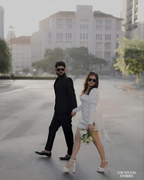 A confident stride across an empty city street. This image captures the essence of a modern love story: stylish, bold, and in step with one another. The architecture provides a clean, powerful backdrop for their connection.