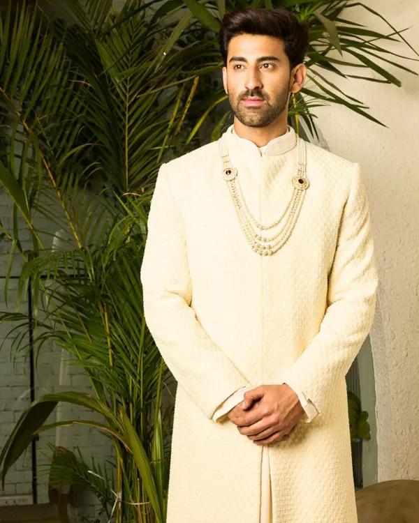 This is my signature off-white sherwani, designed for the modern groom. The piece features a subtle, textured fabric and is tailored for a clean, regal silhouette, offering timeless elegance for your most significant day.
