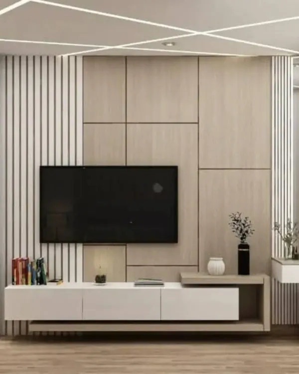 A modern TV unit design with a mix of wood, white panels, and vertical slats. The integrated shelving provides space for decor and books.