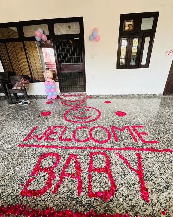 A simple and heartfelt welcome message created with red rose petals on the floor. This "WELCOME BABY" floor art is a beautiful way to greet the newborn at the entrance of your home.