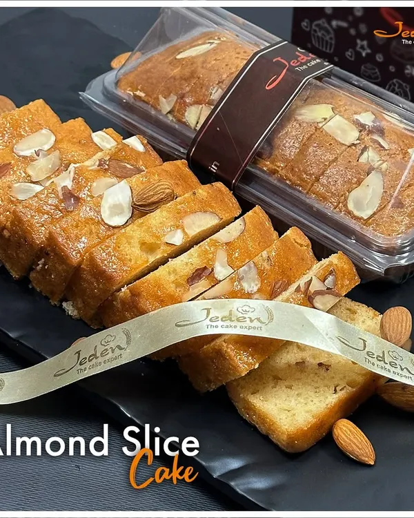 Our Almond Slice Cake is a timeless classic. This moist and buttery cake is generously topped with sliced almonds, offering a delightful crunch and nutty flavor in every bite. It's perfect for any time of day.