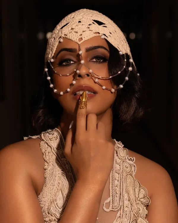 A striking close-up from a Vogue India shoot, where the makeup was designed to be as artistic as the fashion. The intense eye makeup and unique pearl face accessory create a memorable, high-concept image.