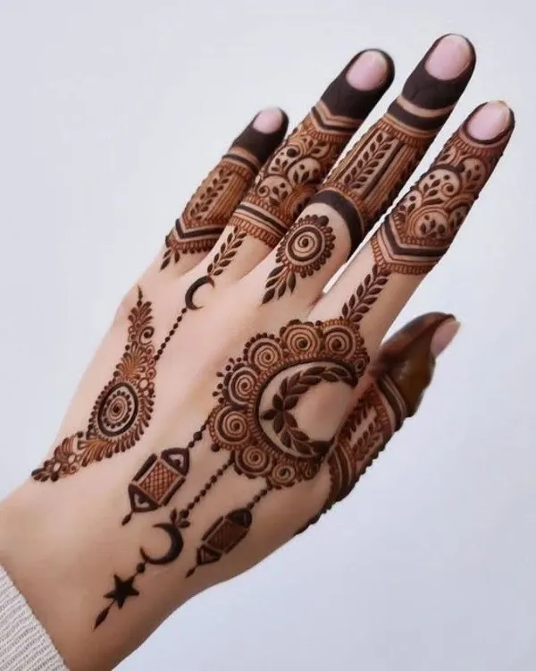An elegant and modern Eid mehndi design. This style uses delicate crescents, stars, and lantern motifs, combined with fine jewelry-like patterns, to celebrate the spirit of Eid. It is light, beautiful, and perfect for the occasion.