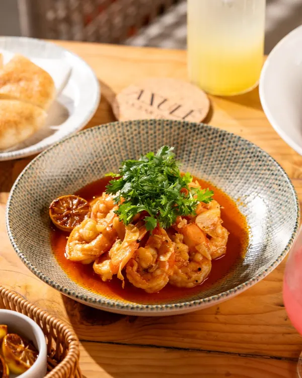 A bowl of delicious garlic prawns from Azule, Goa. The bright, natural light gives it a fresh, beach-side feel.