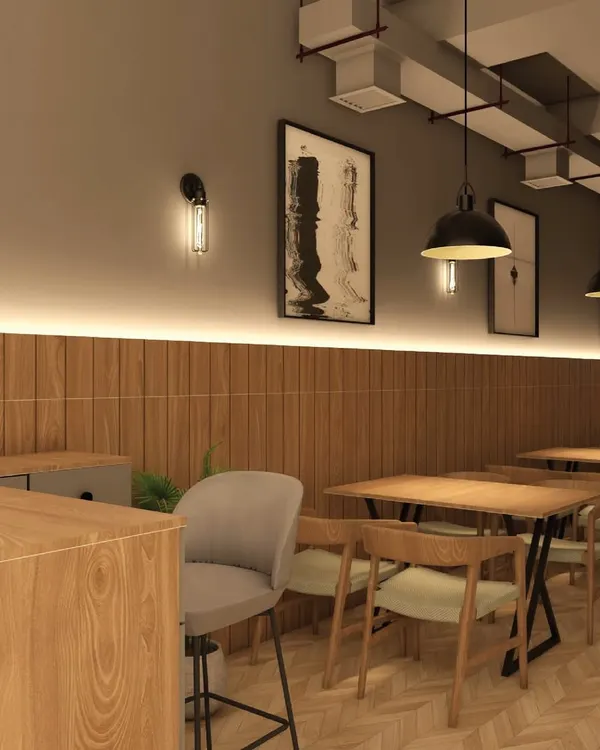 The lighting and material choices in a cafe are essential for setting the mood. Here, I combined warm wood paneling with soft, layered lighting from wall sconces and strip lights to create a welcoming and dynamic atmosphere for patrons.