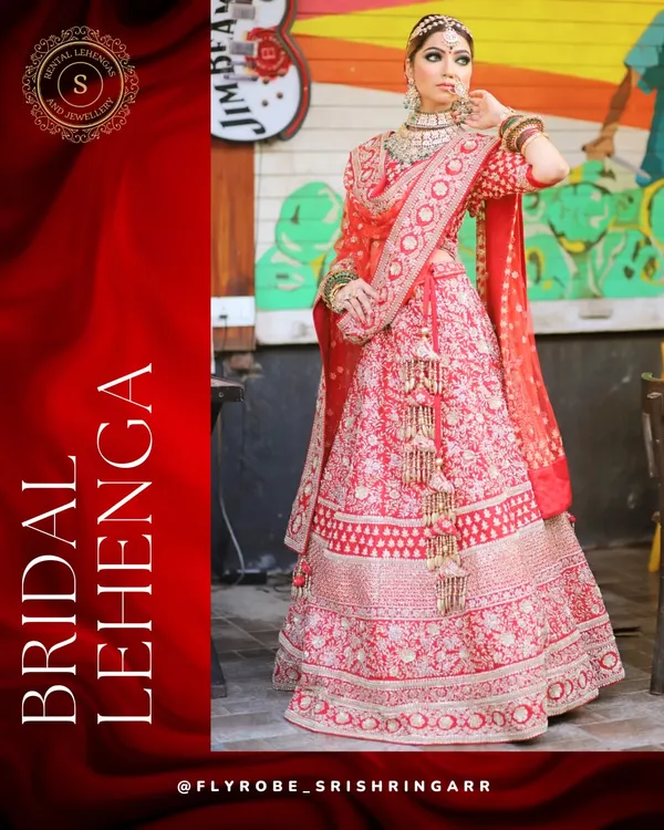 A classic red bridal lehenga with intricate all-over embroidery. This is a timeless choice for the main wedding ceremony, giving you that quintessential Indian bride look.